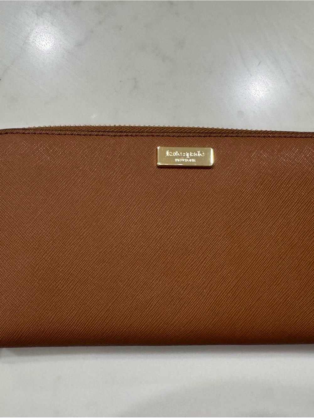 kate spade saffiano zip-around wallet in cognac brown with gold plaque